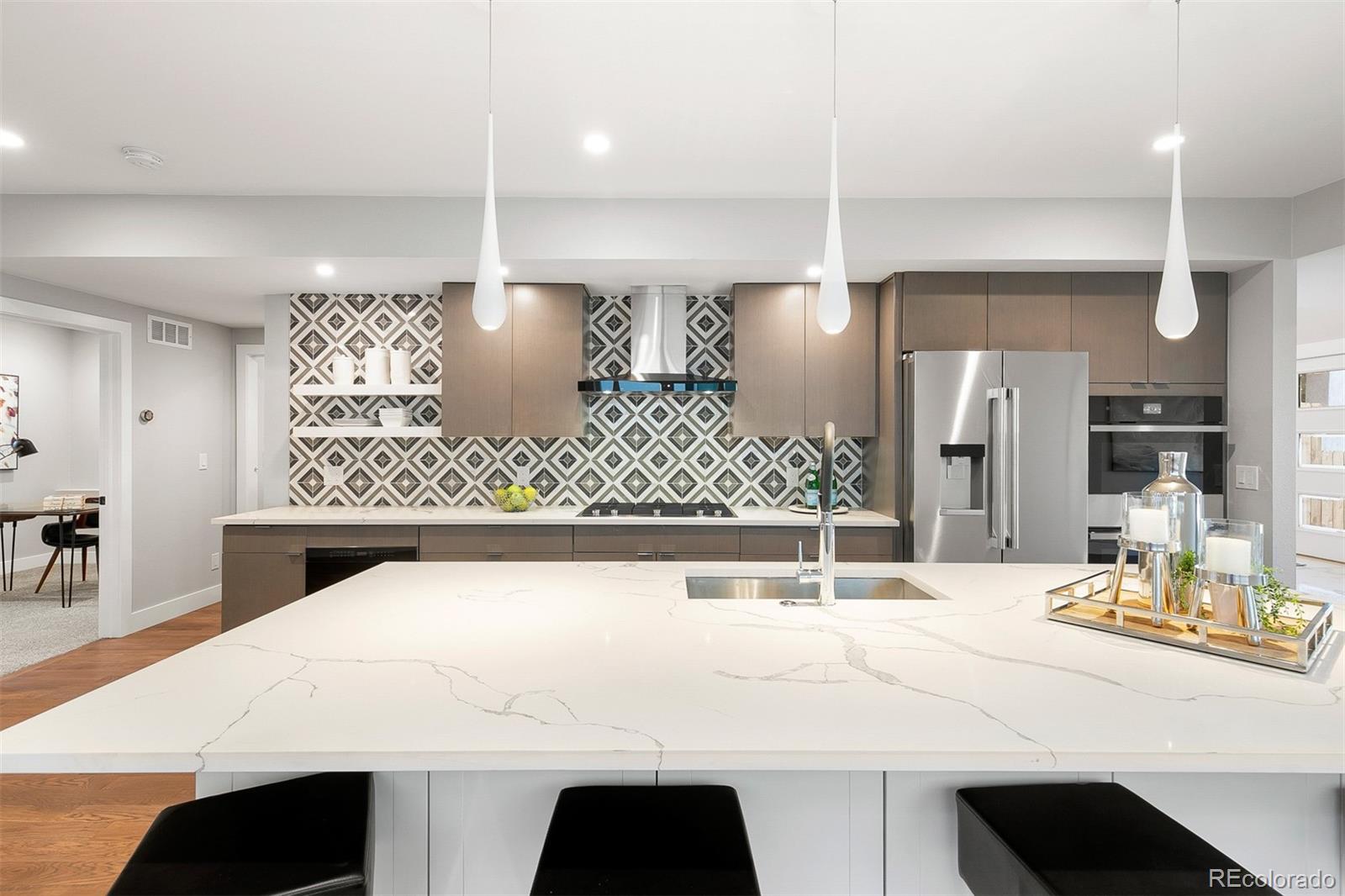 3935 Jason Street Denver, CO 80211 - Photo 1 of 34 a kitchen with a sink a table and chairs