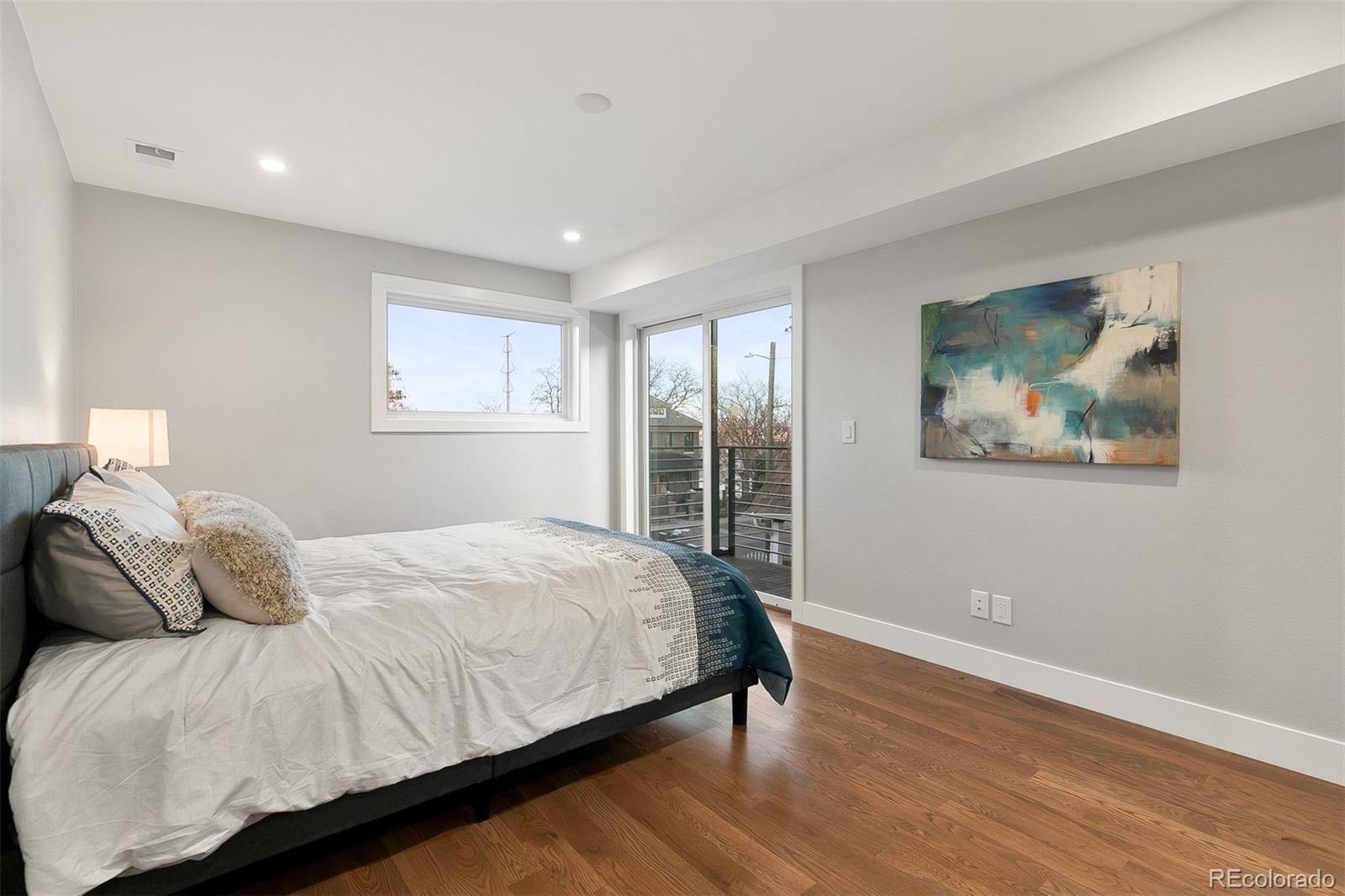 3935 Jason Street Denver, CO 80211 - Photo 13 of 34 a bedroom with a bed and wooden floor