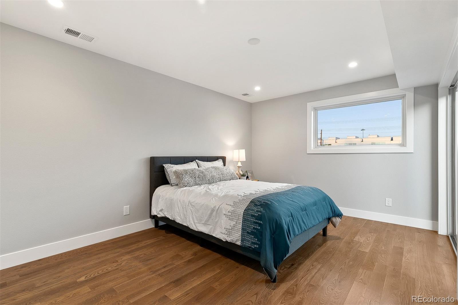 3935 Jason Street Denver, CO 80211 - Photo 14 of 34 a bedroom with a bed and painting on the wall