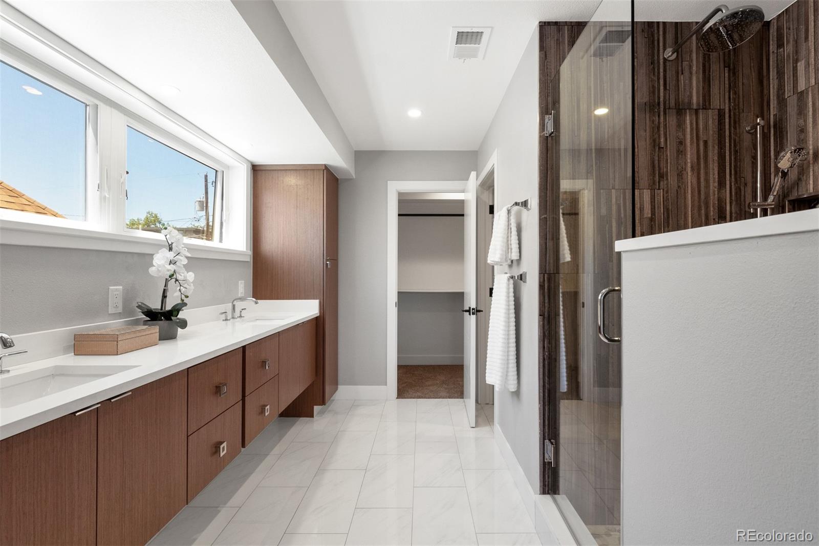 3935 Jason Street Denver, CO 80211 - Photo 15 of 34 a bathroom with a double vanity sink and mirror