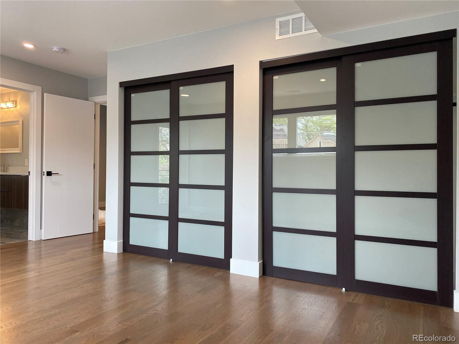 3935 Jason Street Denver, CO 80211 - Photo 19 of 34 wooden floor in an empty room with a window