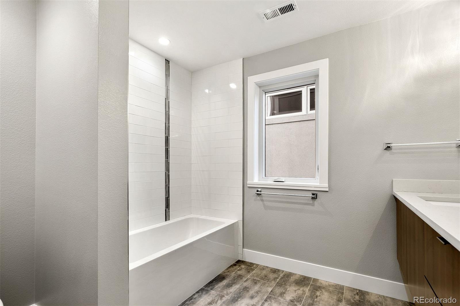 3935 Jason Street Denver, CO 80211 - Photo 21 of 34 a bathroom with a bathtub and a window
