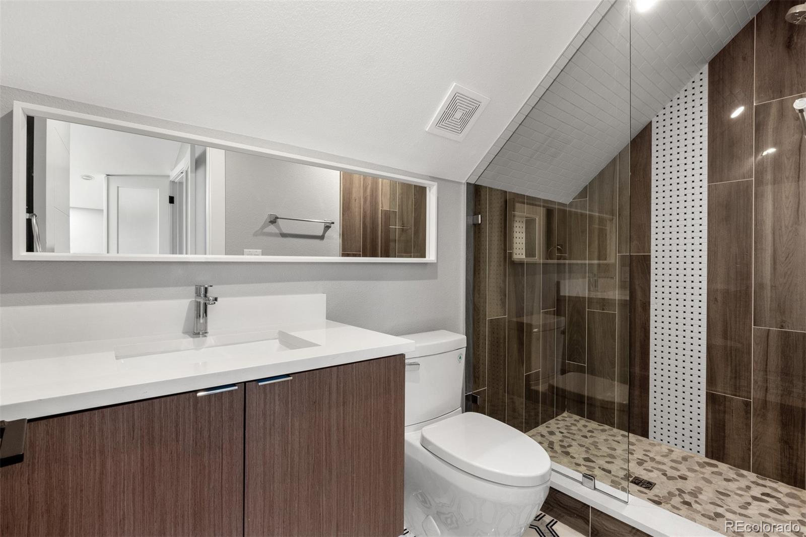 3935 Jason Street Denver, CO 80211 - Photo 24 of 34 a bathroom with a sink a toilet and shower