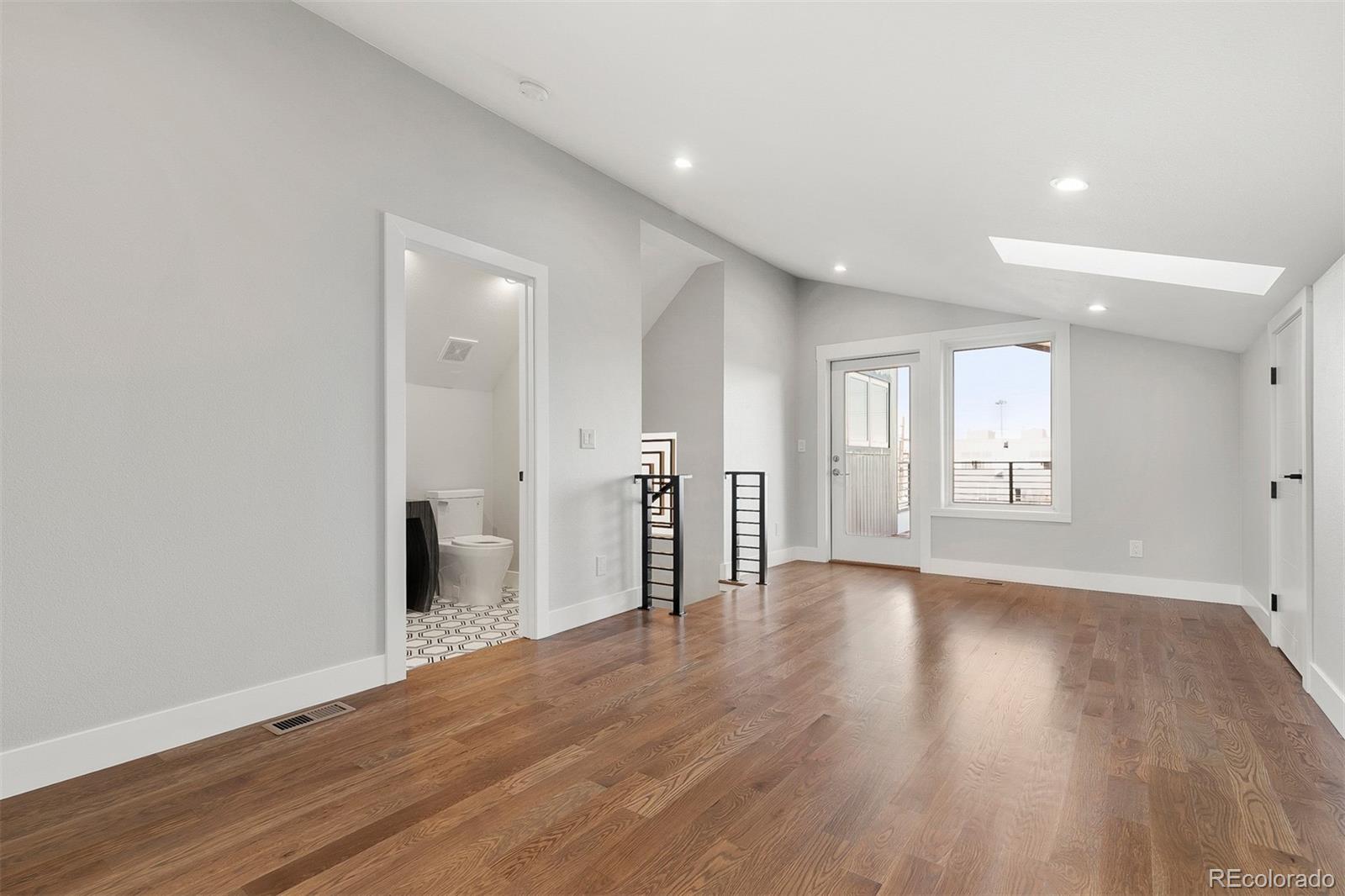 3935 Jason Street Denver, CO 80211 - Photo 25 of 34 a view of a hallway with wooden floor and a large window