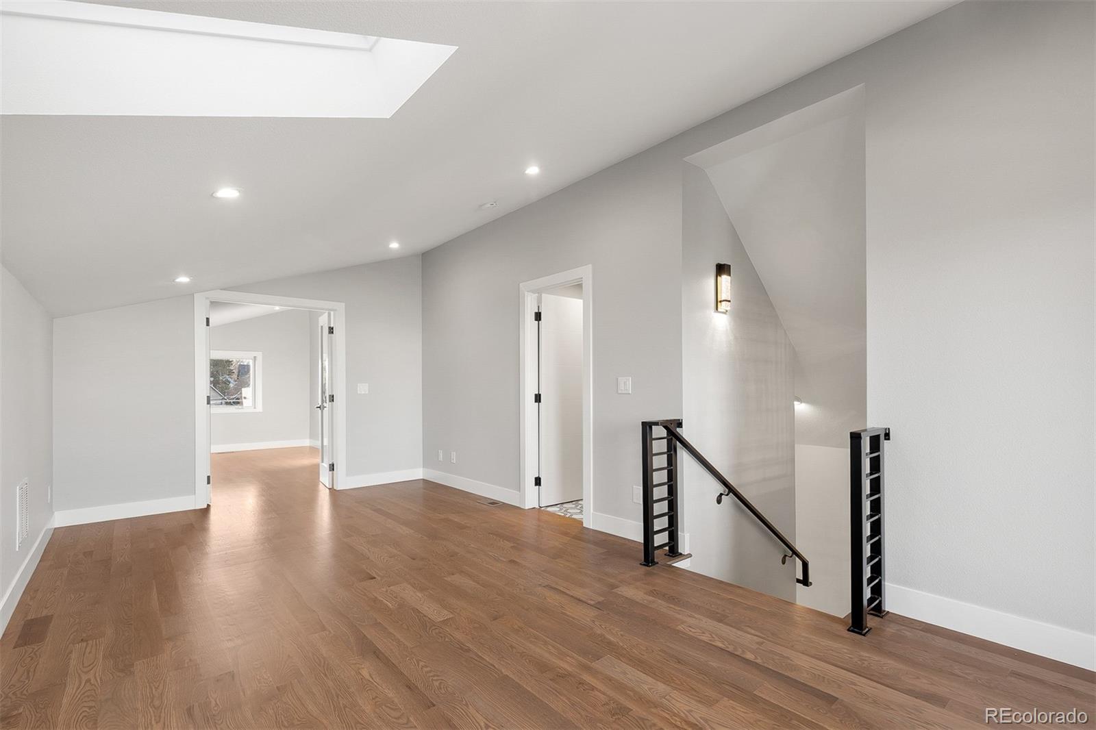 3935 Jason Street Denver, CO 80211 - Photo 26 of 34 a view of a hallway with wooden floor