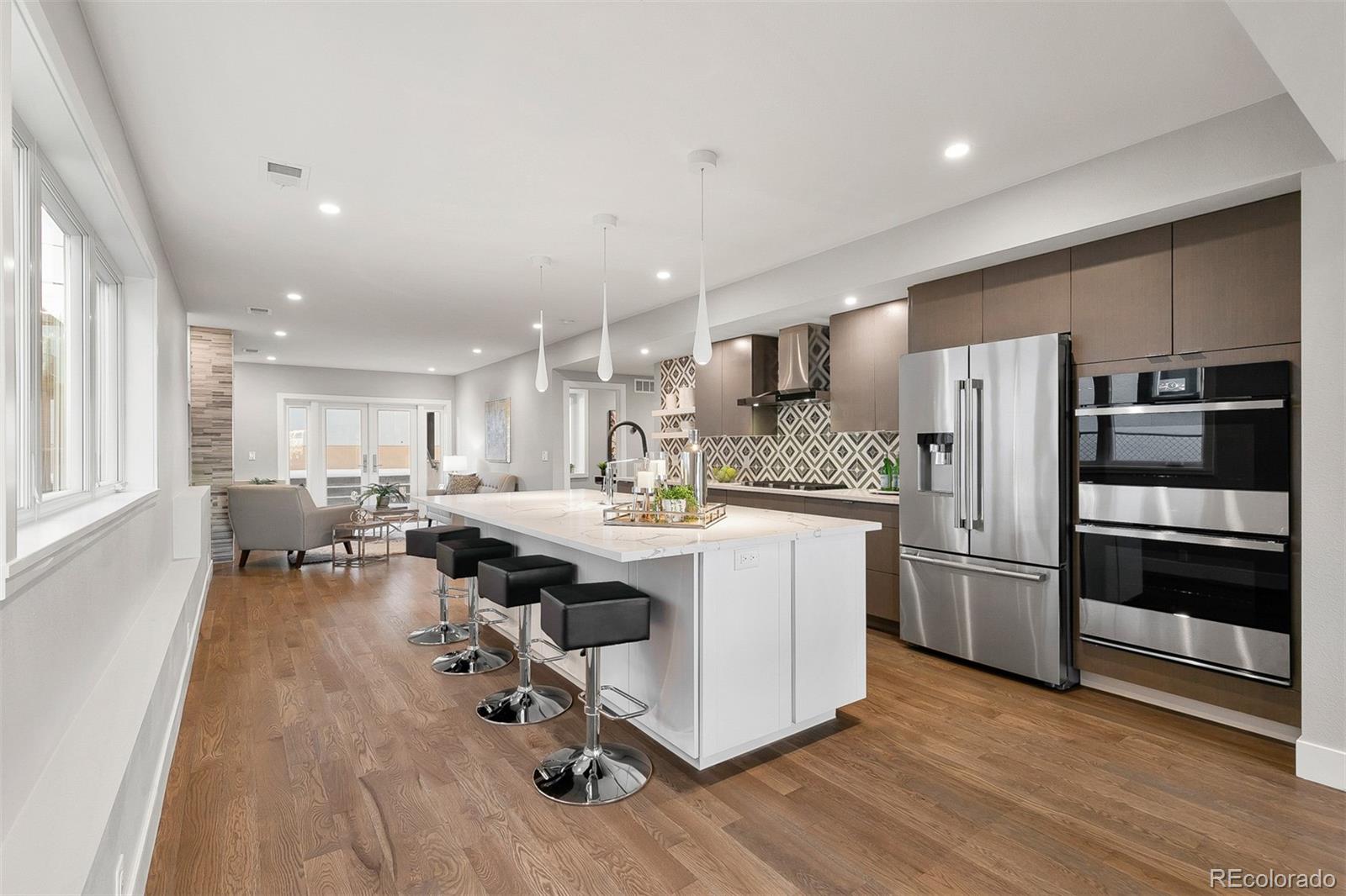 3935 Jason Street Denver, CO 80211 - Photo 4 of 34 a kitchen with stainless steel appliances granite countertop a lot of counter space and wooden floor