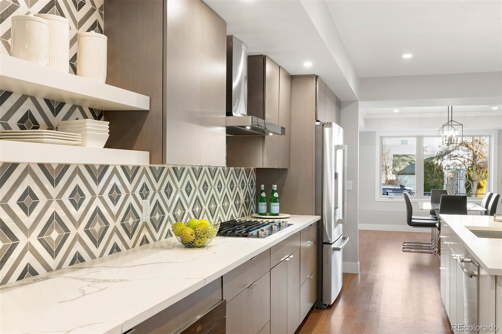 3935 Jason Street Denver, CO 80211 - Photo 5 of 34 a kitchen with a sink and refrigerator