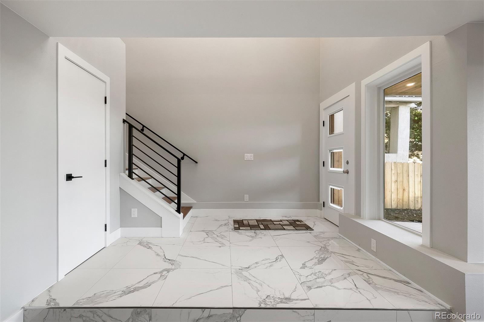 3935 Jason Street Denver, CO 80211 - Photo 10 of 34 a view of a livingroom with stairs and furniture
