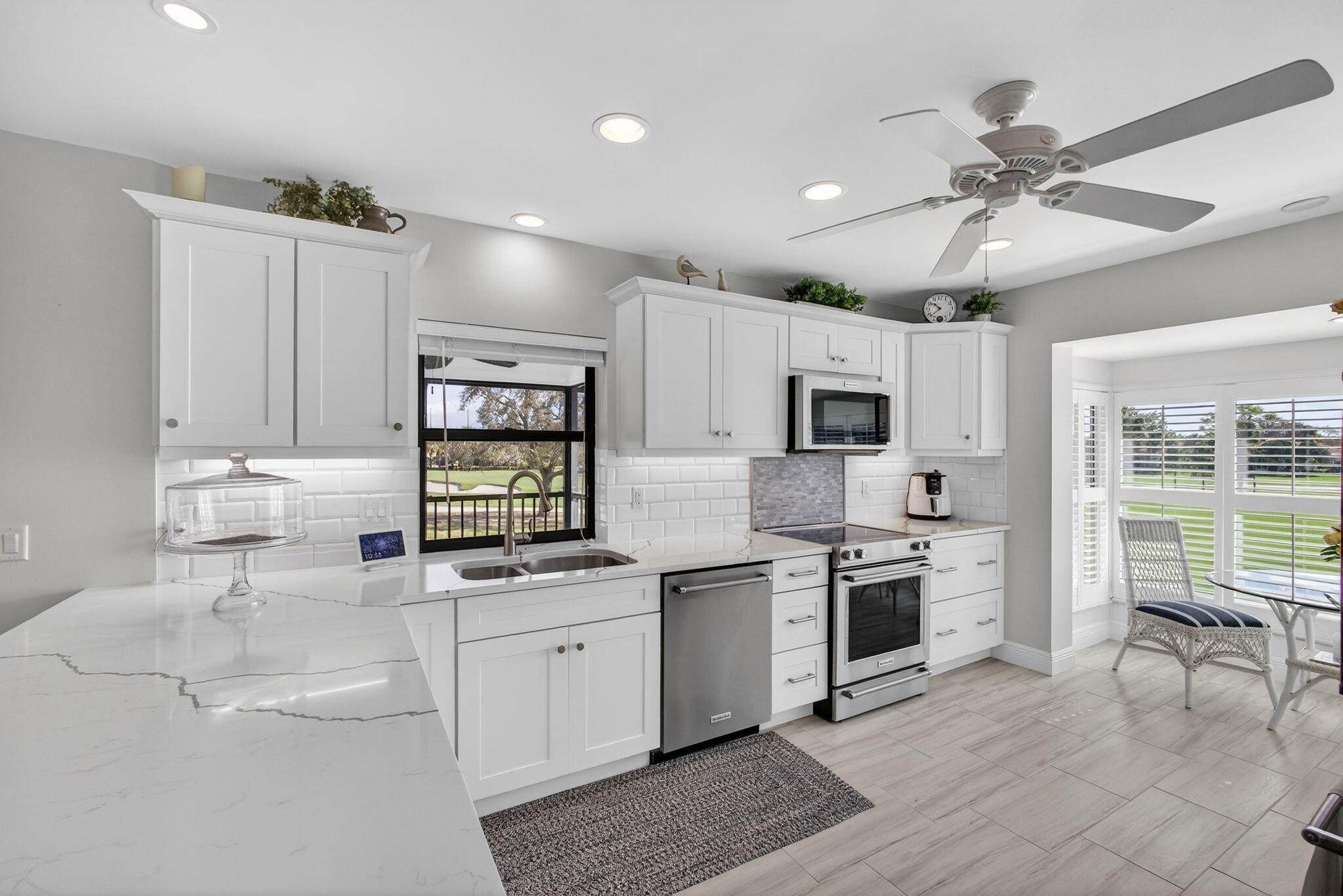 16550 Traders Crossing South, Unit 248 Jupiter, FL 33477 - Photo 13 of 50 a kitchen with cabinets a sink and stainless steel appliances