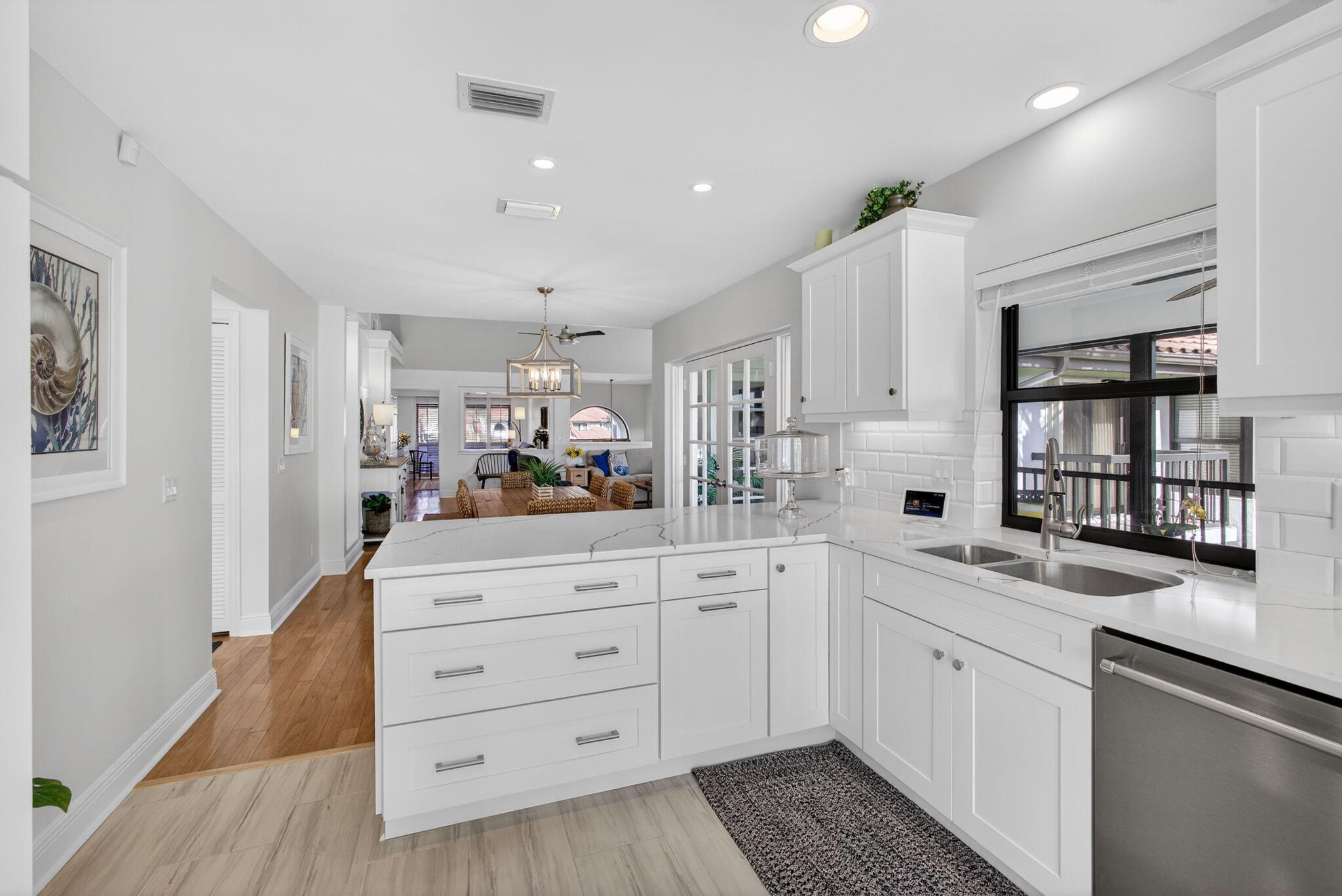 16550 Traders Crossing South, Unit 248 Jupiter, FL 33477 - Photo 19 of 50 a kitchen with granite countertop white cabinets and white appliances