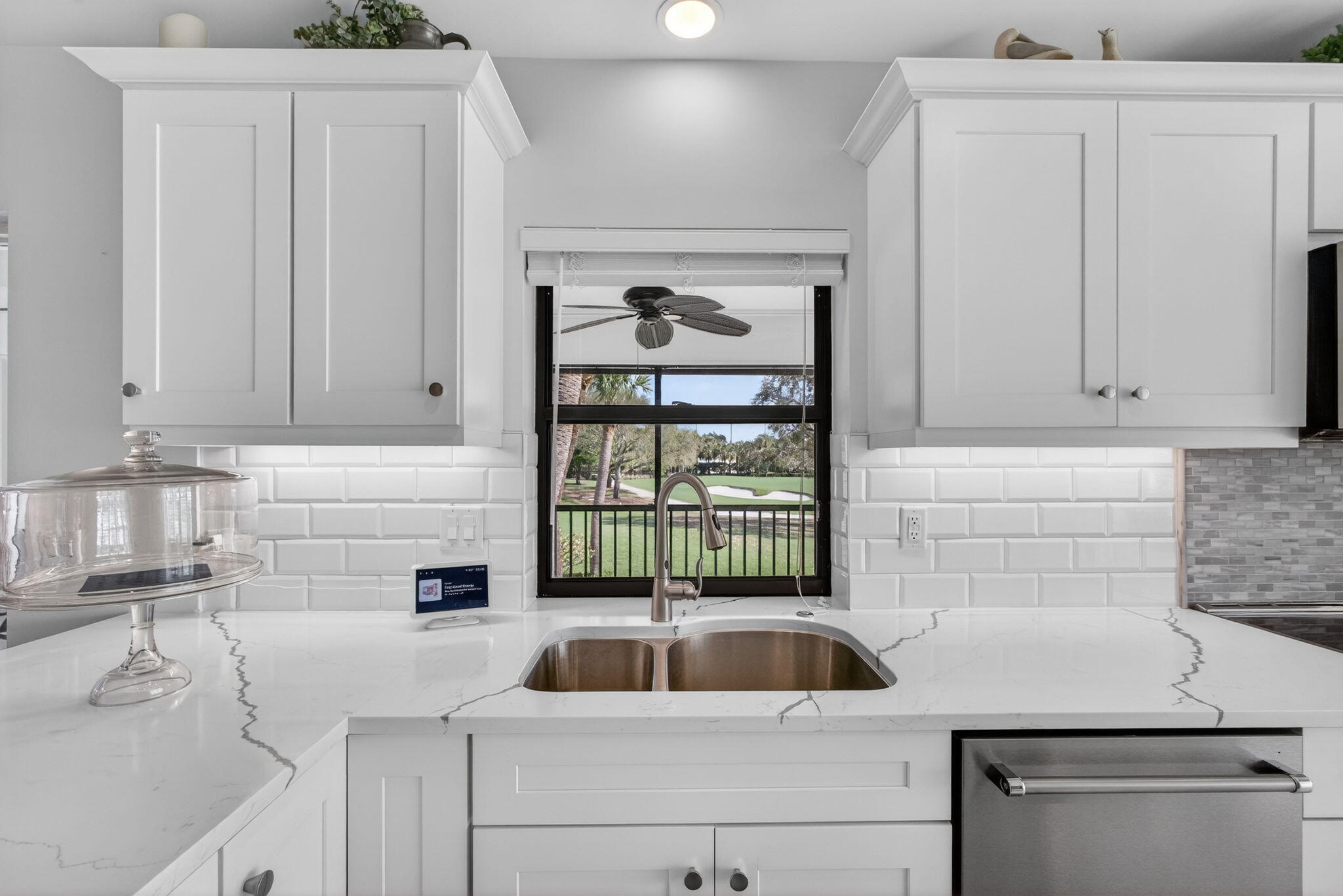 16550 Traders Crossing South, Unit 248 Jupiter, FL 33477 - Photo 20 of 50 a kitchen with white cabinets and a sink