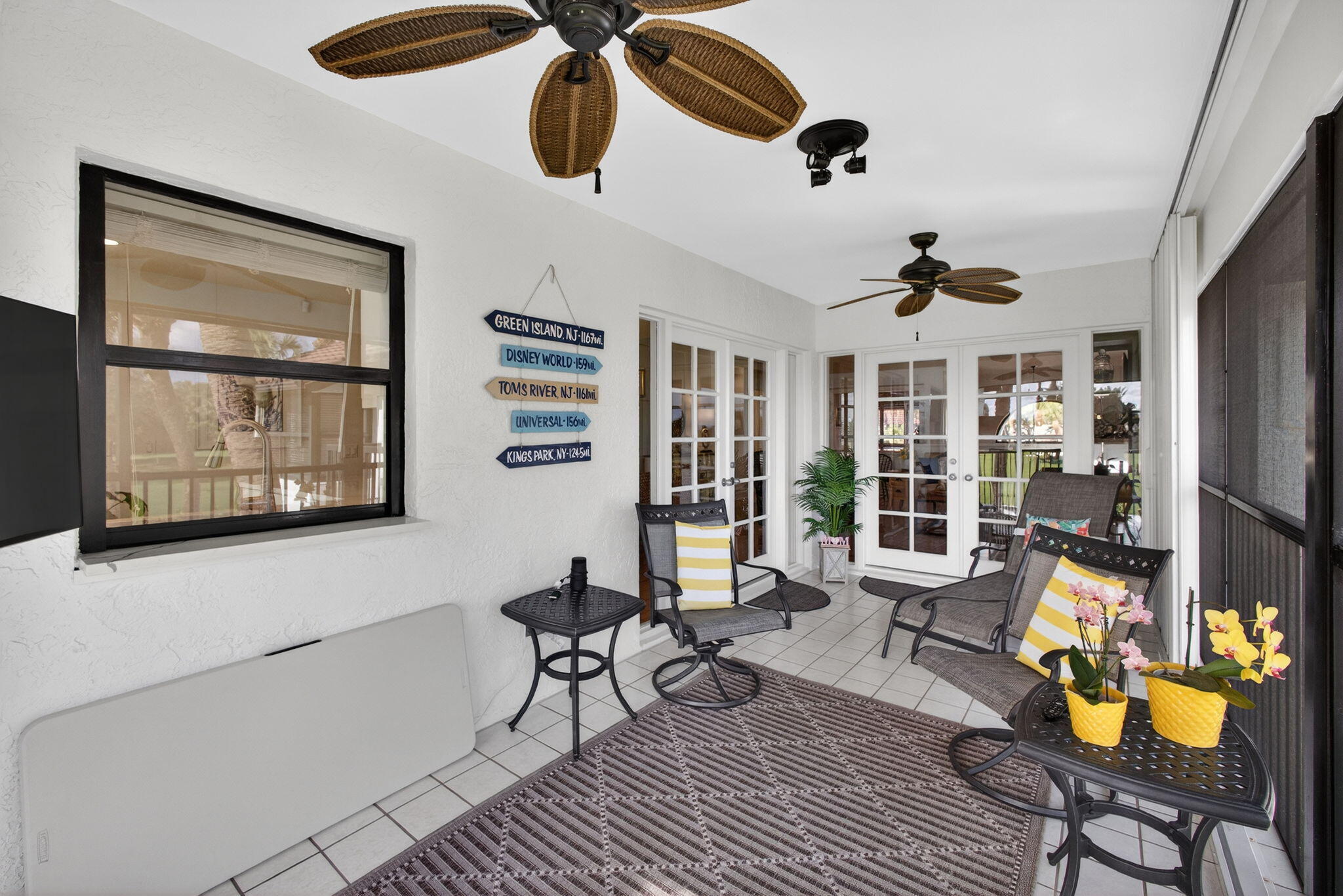 16550 Traders Crossing South, Unit 248 Jupiter, FL 33477 - Photo 26 of 50 a living room with furniture and floor to ceiling windows