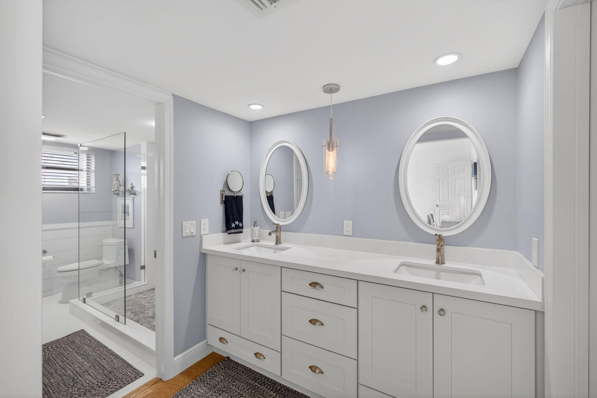 16550 Traders Crossing South, Unit 248 Jupiter, FL 33477 - Photo 29 of 50 a bathroom with a double vanity sink mirror and shower