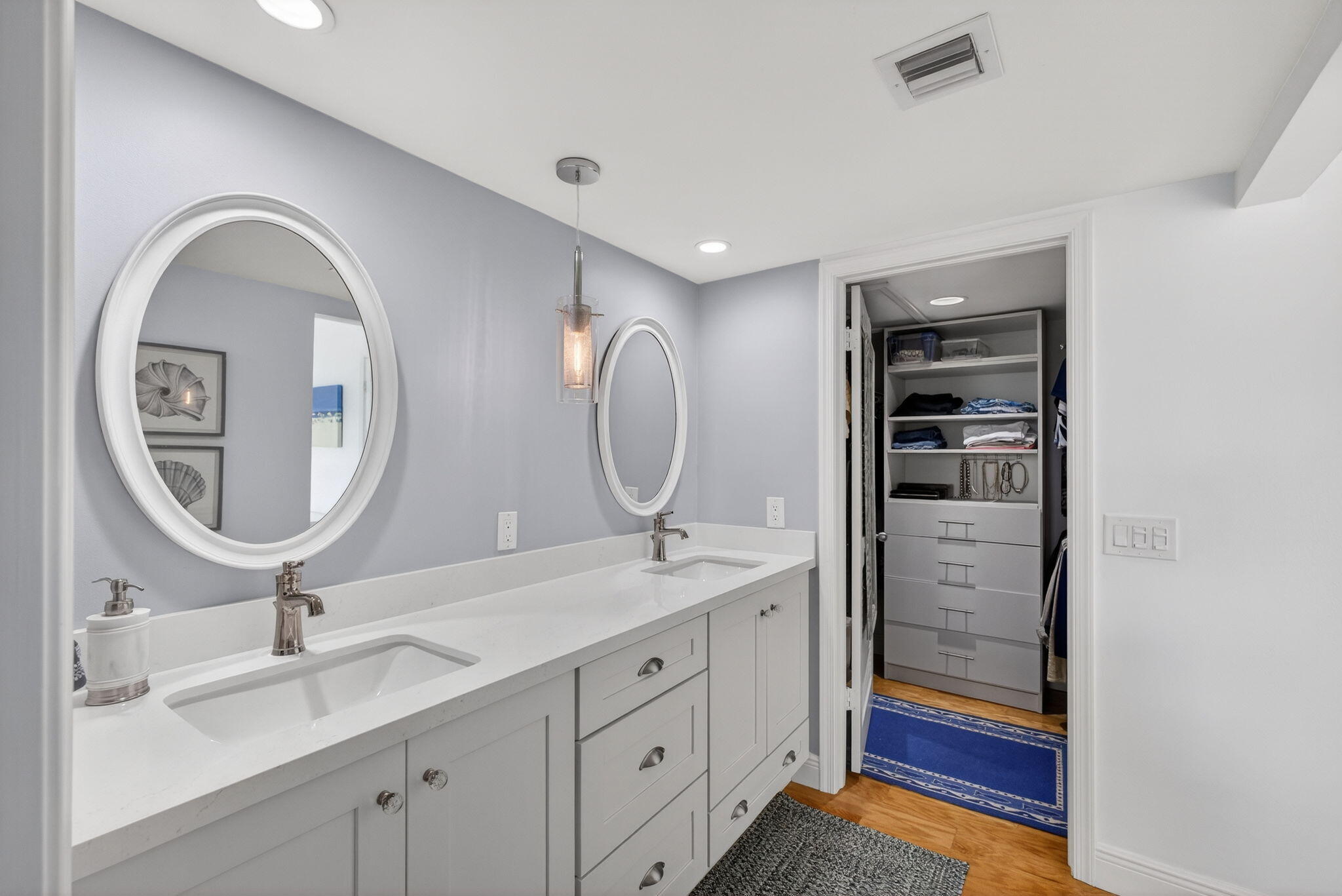 16550 Traders Crossing South, Unit 248 Jupiter, FL 33477 - Photo 32 of 50 a bathroom with a double vanity sink and a mirror