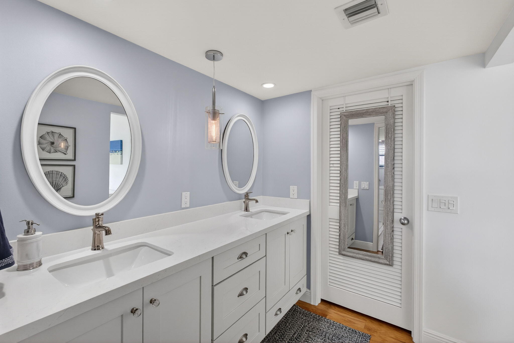 16550 Traders Crossing South, Unit 248 Jupiter, FL 33477 - Photo 33 of 50 a bathroom with a granite countertop double vanity sinks and a mirror
