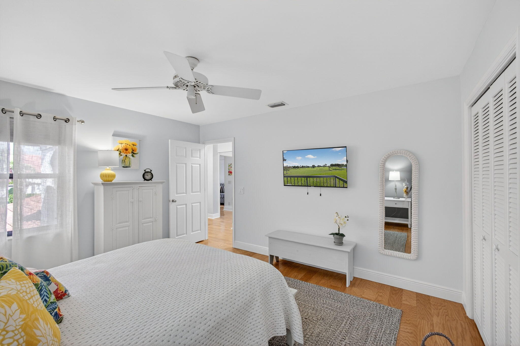 16550 Traders Crossing South, Unit 248 Jupiter, FL 33477 - Photo 38 of 50 a bedroom with a bed and a chandelier