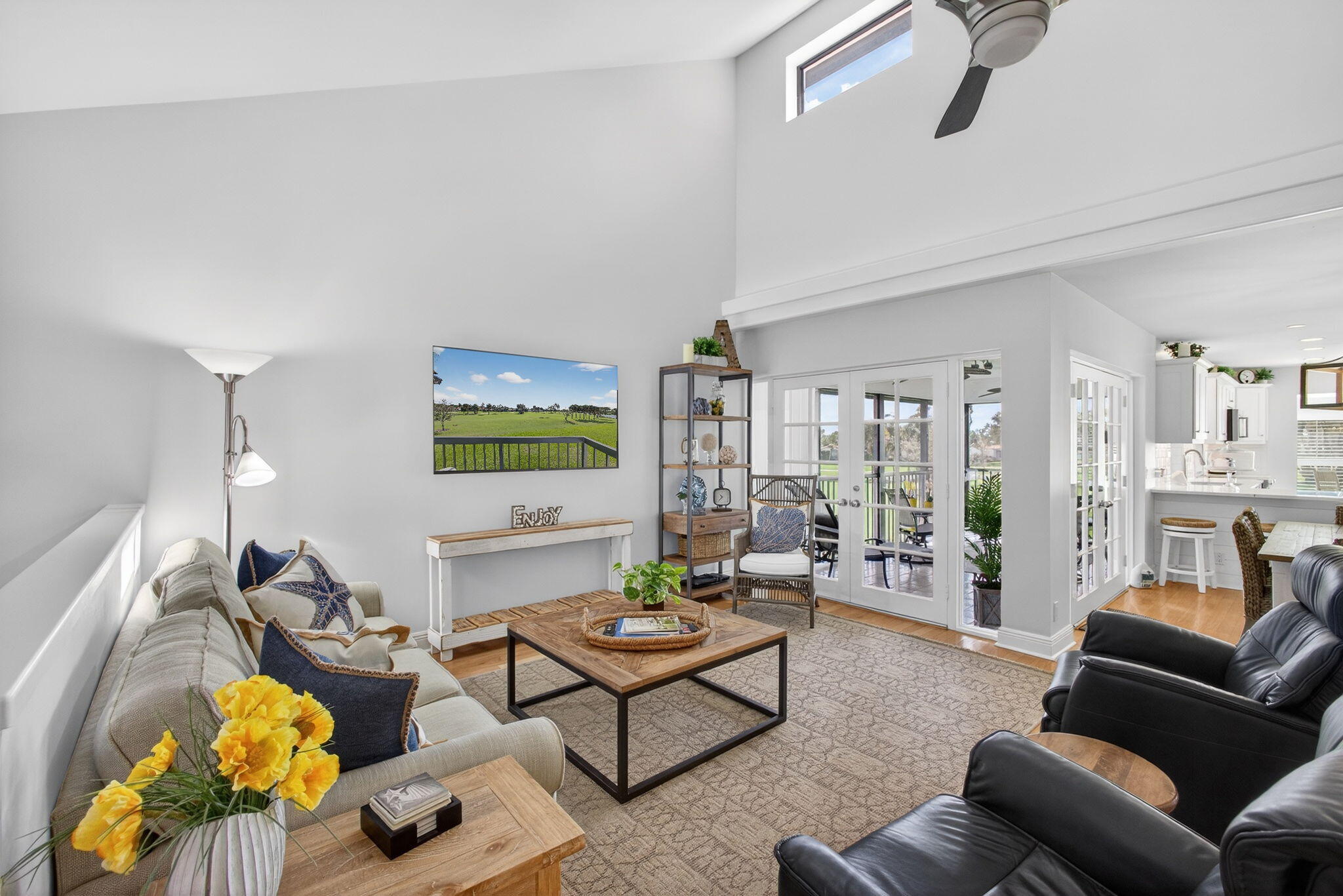 16550 Traders Crossing South, Unit 248 Jupiter, FL 33477 - Photo 6 of 50 a living room with furniture and a flat screen tv