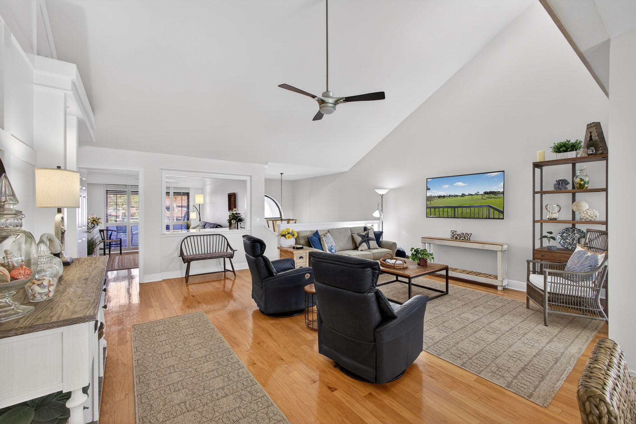 16550 Traders Crossing South, Unit 248 Jupiter, FL 33477 - Photo 8 of 50 a living room with furniture and a flat screen tv