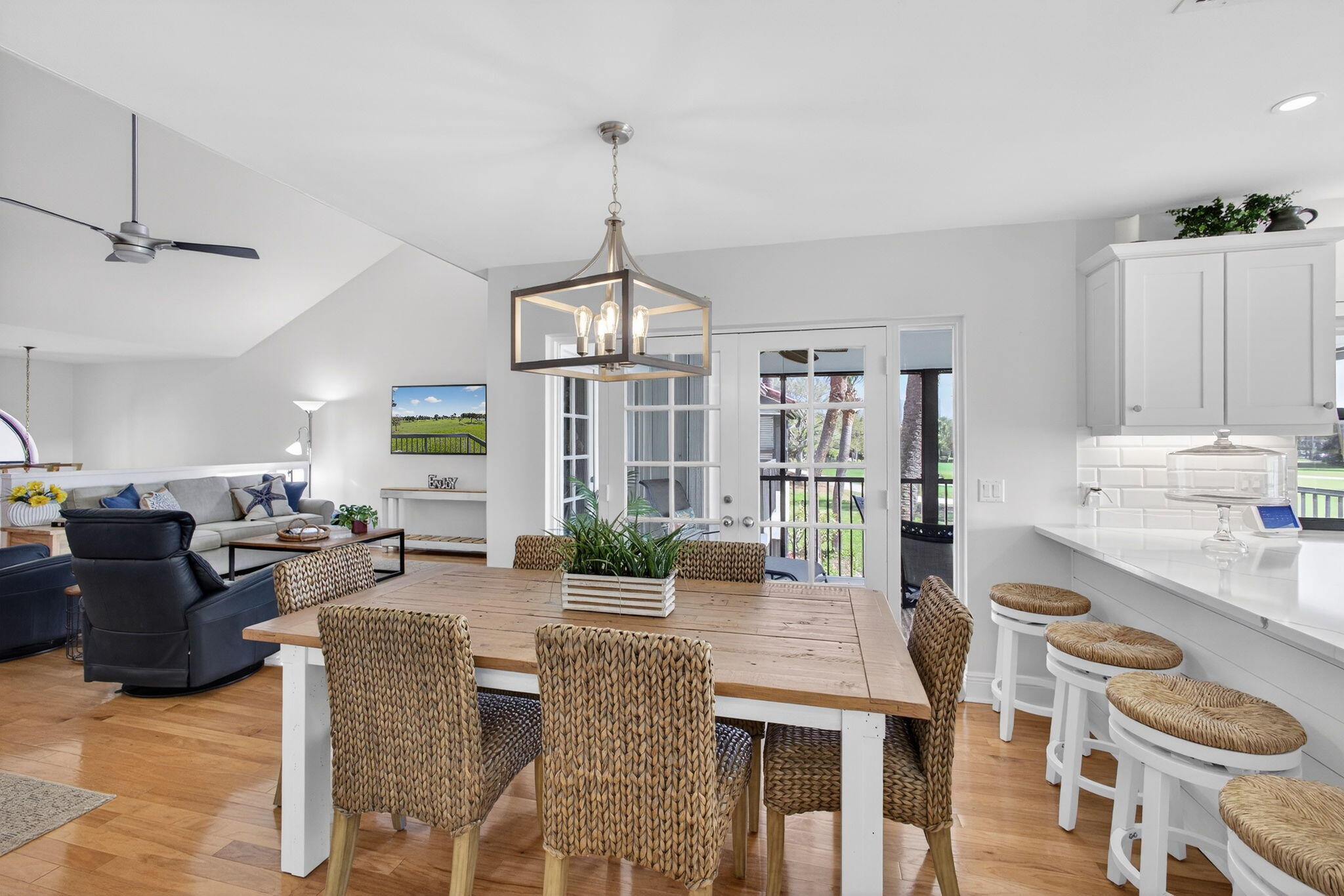 16550 Traders Crossing South, Unit 248 Jupiter, FL 33477 - Photo 10 of 50 a living room with furniture a chandelier and a dining table
