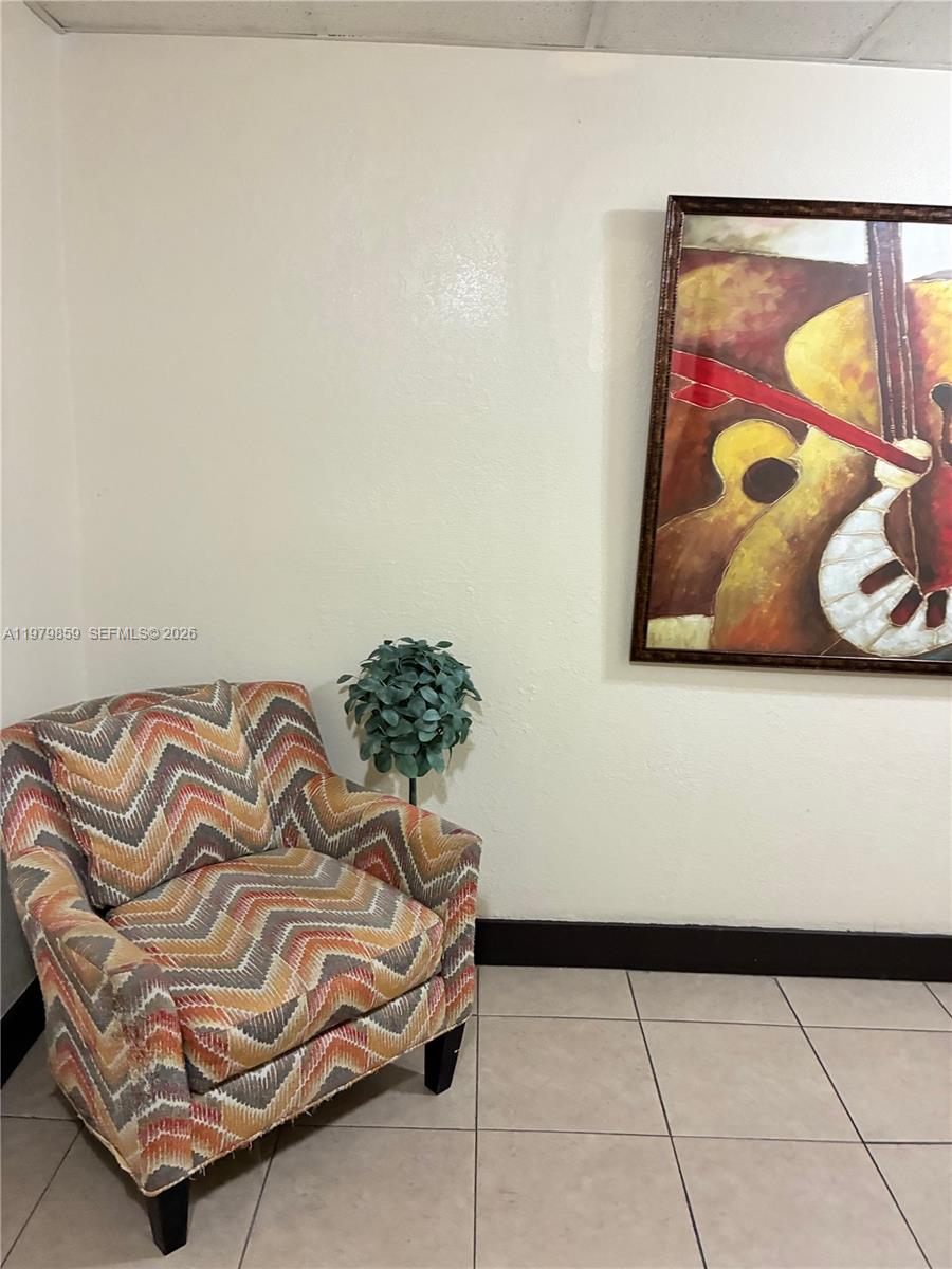 3680 Inverrary Drive, Unit 1T Lauderhill, FL 33319 - Photo 1 of 14 a bedroom with a bed and painting on the wall