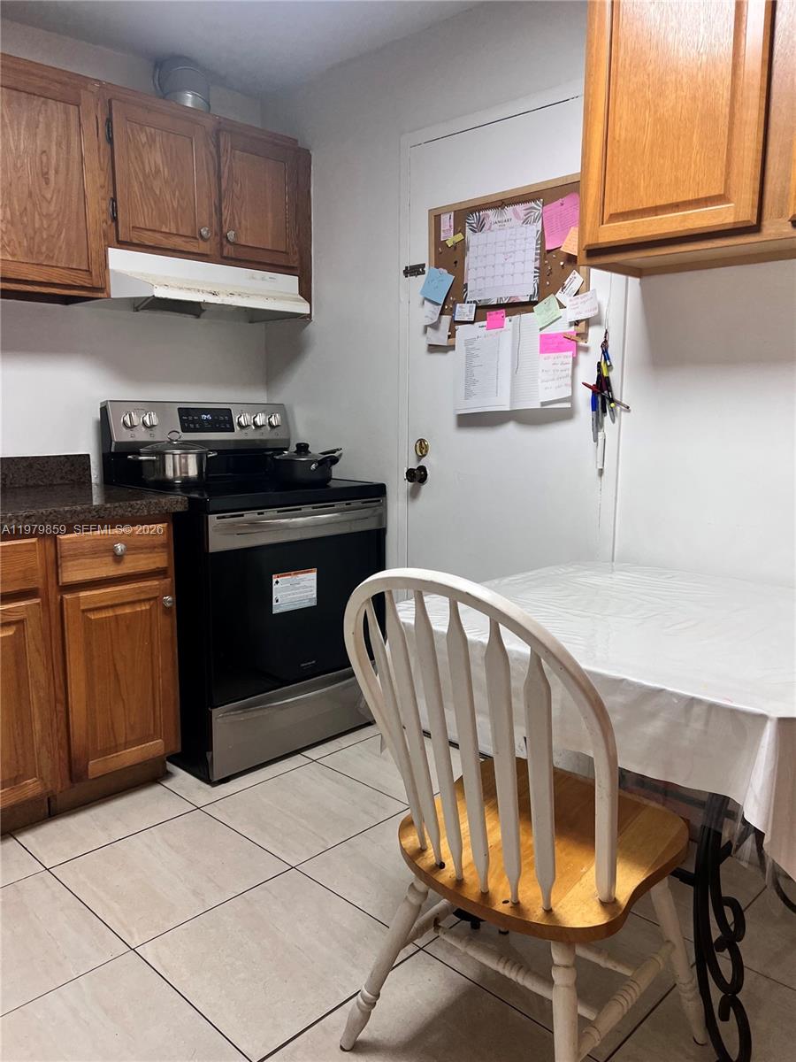 3680 Inverrary Drive, Unit 1T Lauderhill, FL 33319 - Photo 12 of 14 a kitchen with stainless steel appliances granite countertop a stove and cabinets