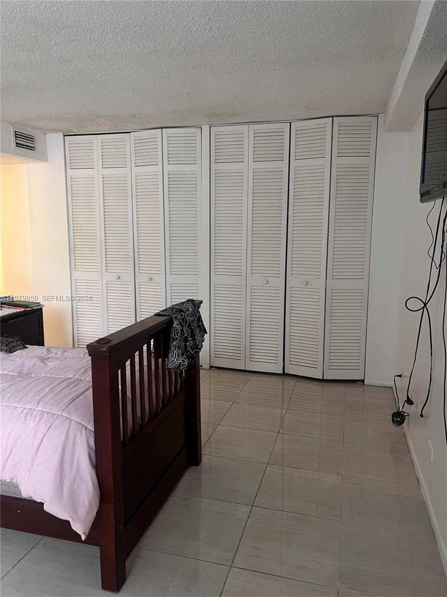 3680 Inverrary Drive, Unit 1T Lauderhill, FL 33319 - Photo 13 of 14 a bed room with a bed and a window