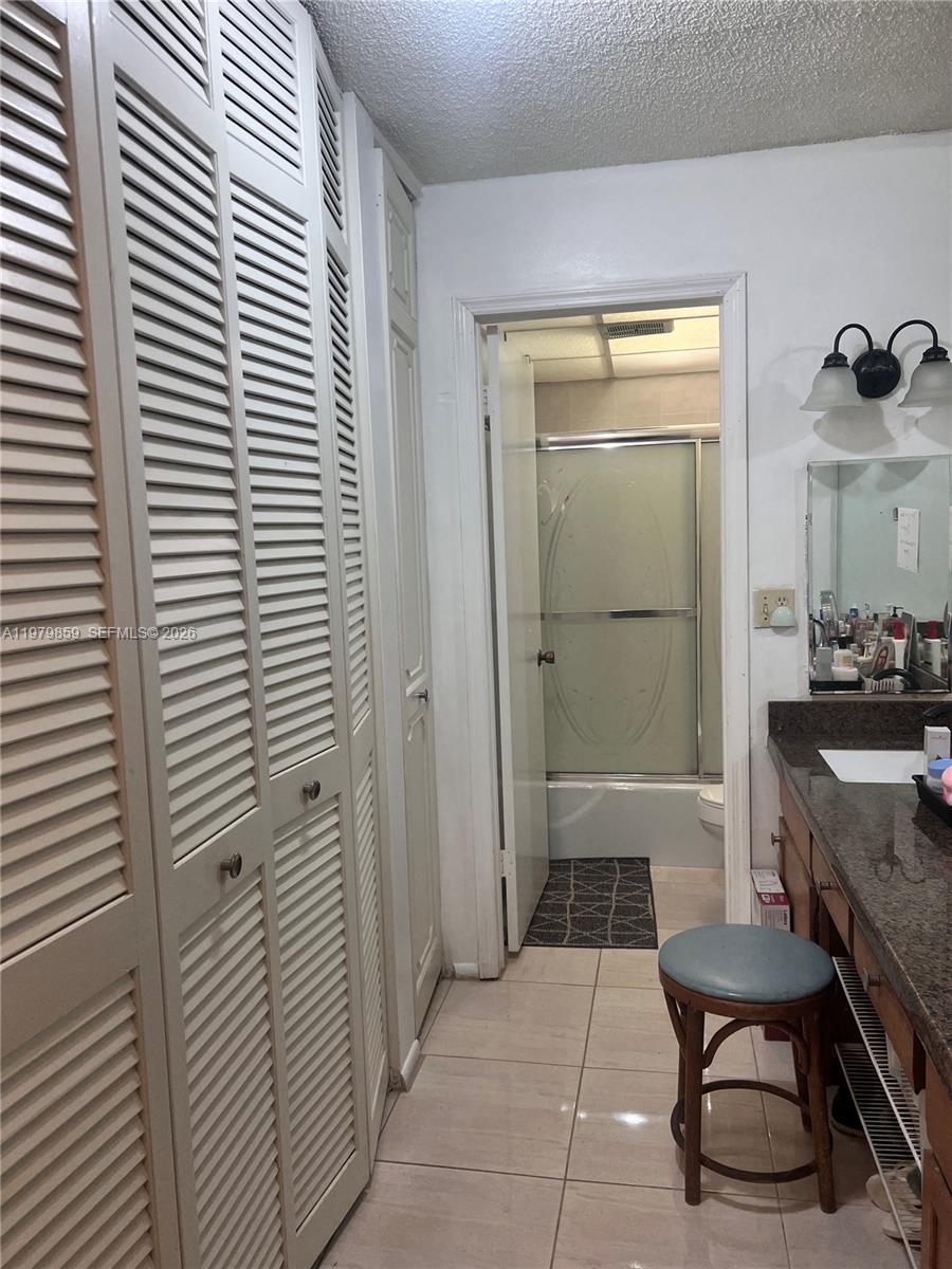 3680 Inverrary Drive, Unit 1T Lauderhill, FL 33319 - Photo 14 of 14 a bathroom with a sink and a mirror