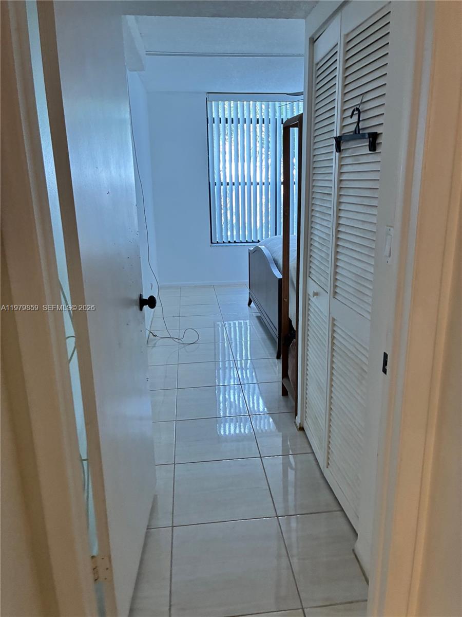 3680 Inverrary Drive, Unit 1T Lauderhill, FL 33319 - Photo 5 of 14 a bathroom with a sink and glass door shower