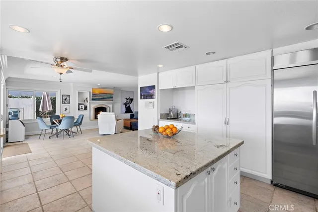 a kitchen with stainless steel appliances granite countertop a sink a stove and a refrigerator