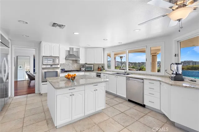 a kitchen with white cabinets and appliances