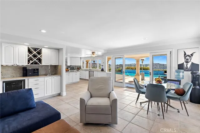 a living room with furniture and a view of kitchen
