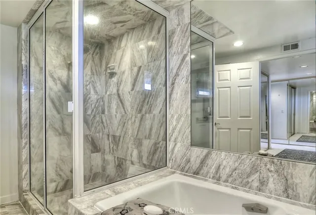 a bathroom with a tub and shower