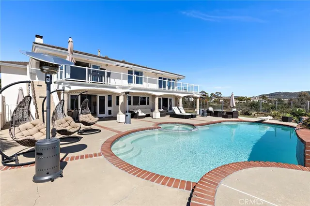 a view of a swimming pool with outdoor seating