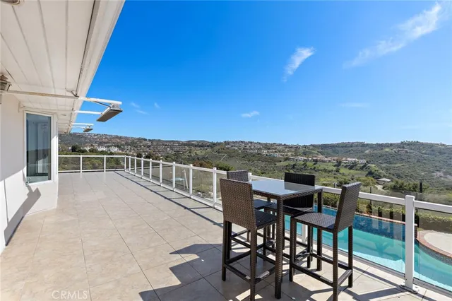 a view of a balcony with table and chairs