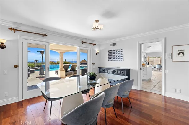 a dining room with furniture a window and wooden floor