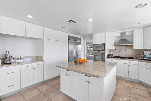 a kitchen with granite countertop a sink stove and cabinets