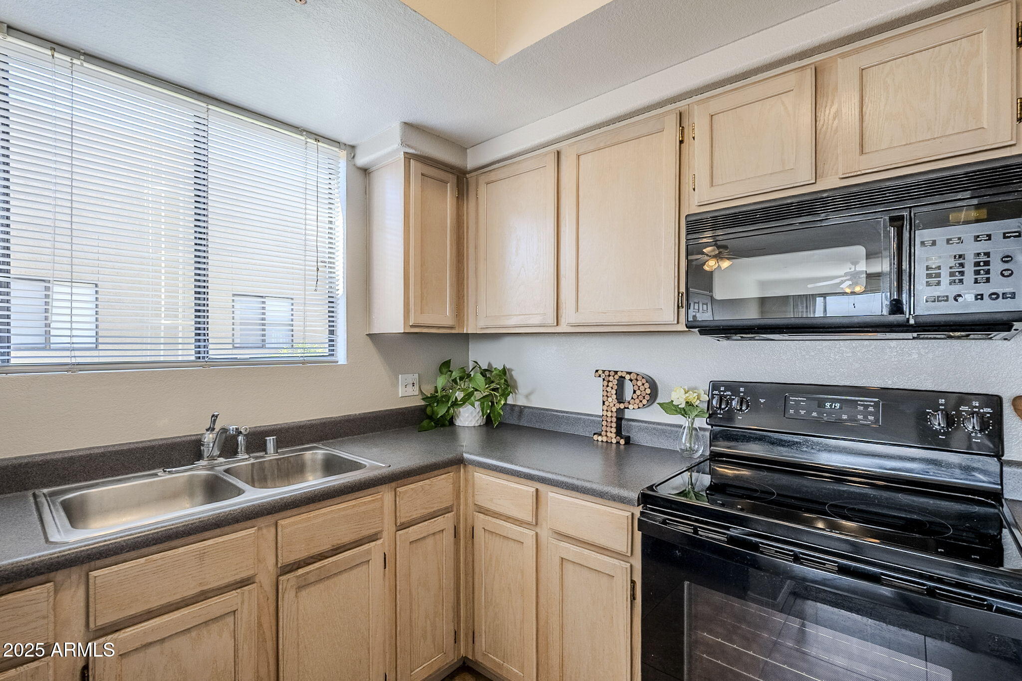4925 East Desert Cove Avenue, Unit 326 Scottsdale, AZ 85254 - Photo 13 of 37 a kitchen with stainless steel appliances granite countertop a sink stove and cabinets