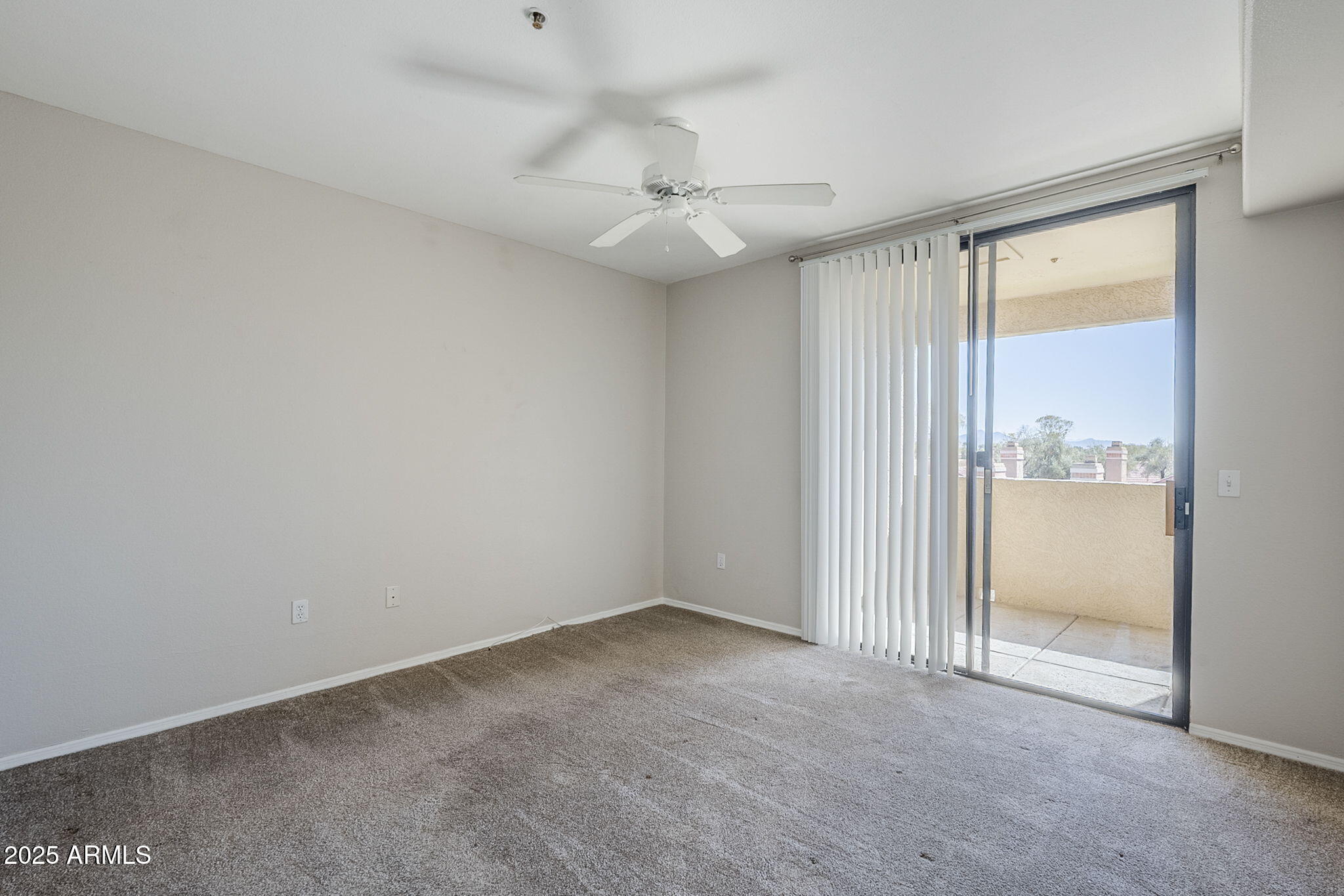 4925 East Desert Cove Avenue, Unit 326 Scottsdale, AZ 85254 - Photo 14 of 37 an empty room with a ceiling fan and a window