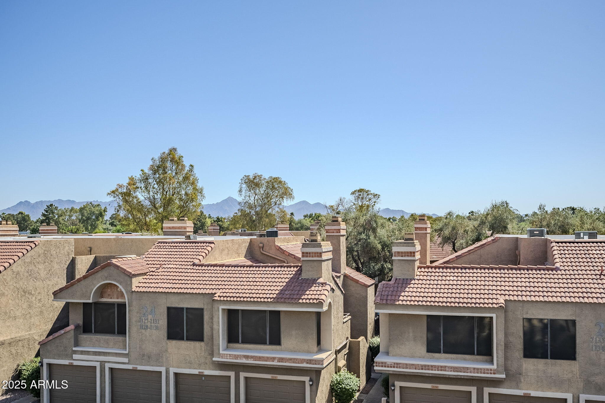 4925 East Desert Cove Avenue, Unit 326 Scottsdale, AZ 85254 - Photo 23 of 37 a view of a white house with large windows