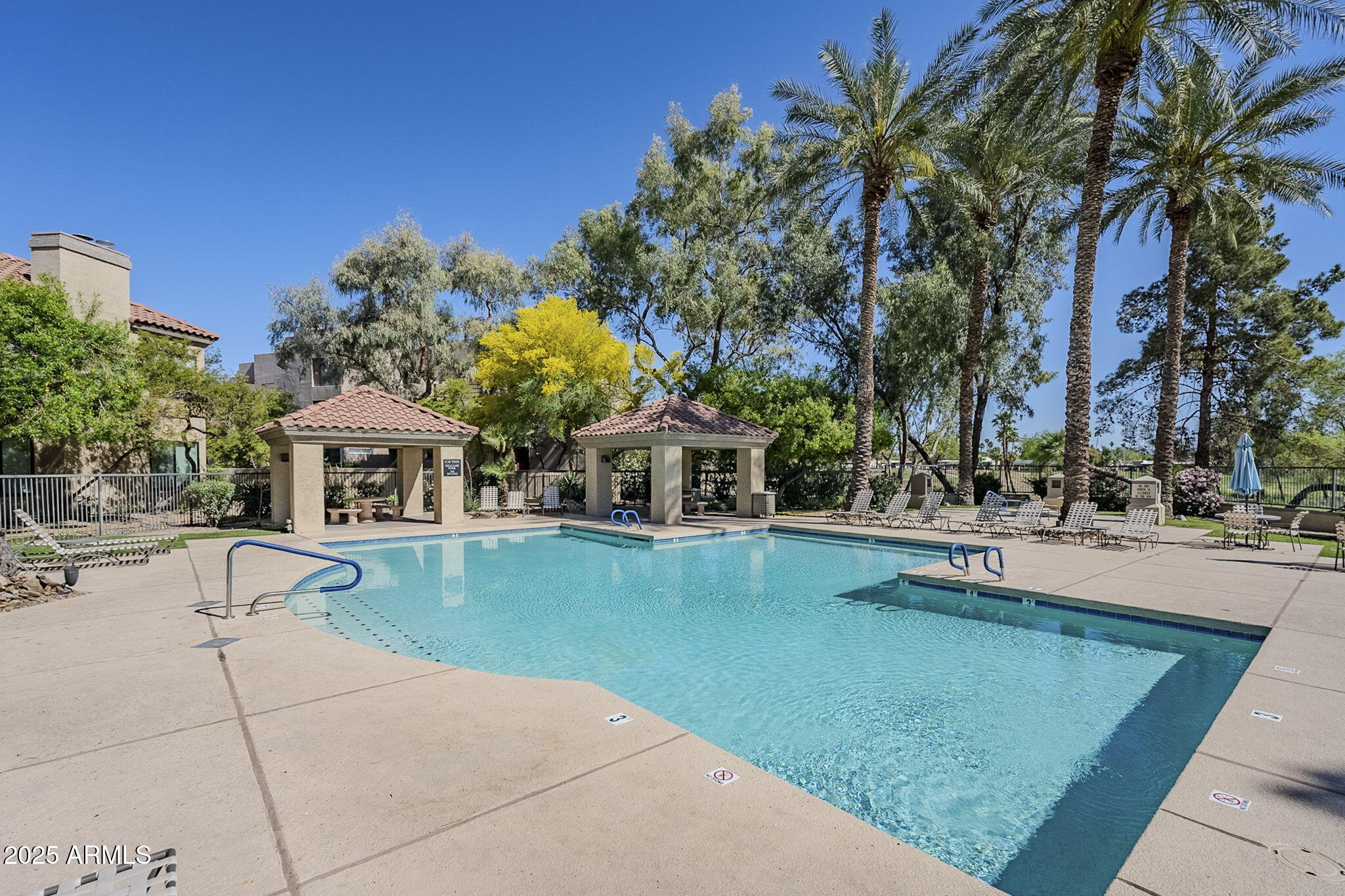 4925 East Desert Cove Avenue, Unit 326 Scottsdale, AZ 85254 - Photo 26 of 37 a swimming pool with outdoor seating and yard