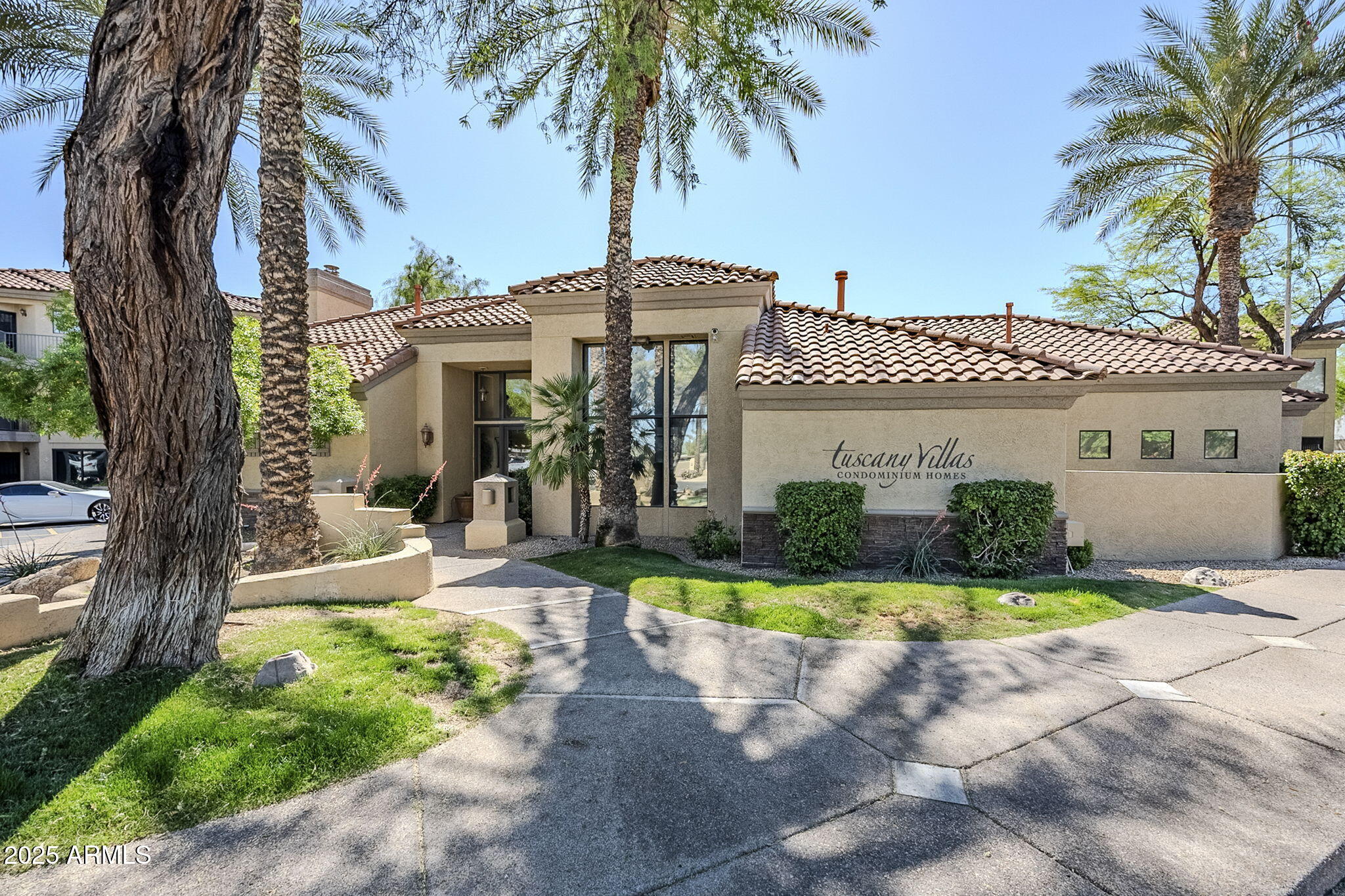 4925 East Desert Cove Avenue, Unit 326 Scottsdale, AZ 85254 - Photo 33 of 37 a front view of a house with a yard and potted plants