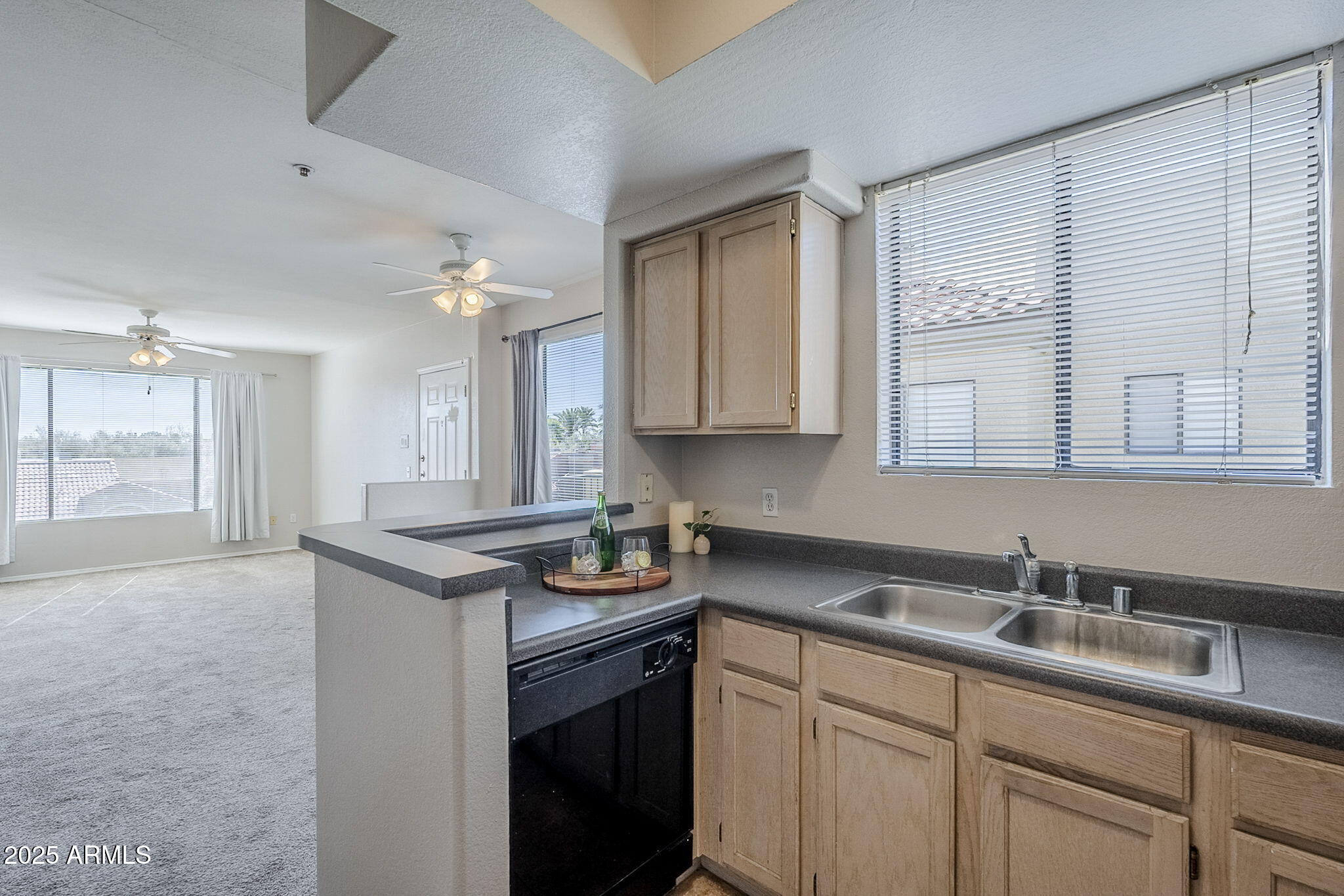 4925 East Desert Cove Avenue, Unit 326 Scottsdale, AZ 85254 - Photo 7 of 37 a kitchen with sink cabinets and window