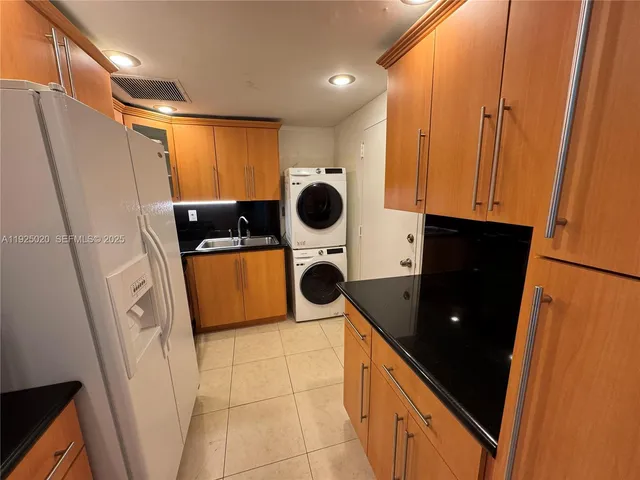 a kitchen with a refrigerator and a stove