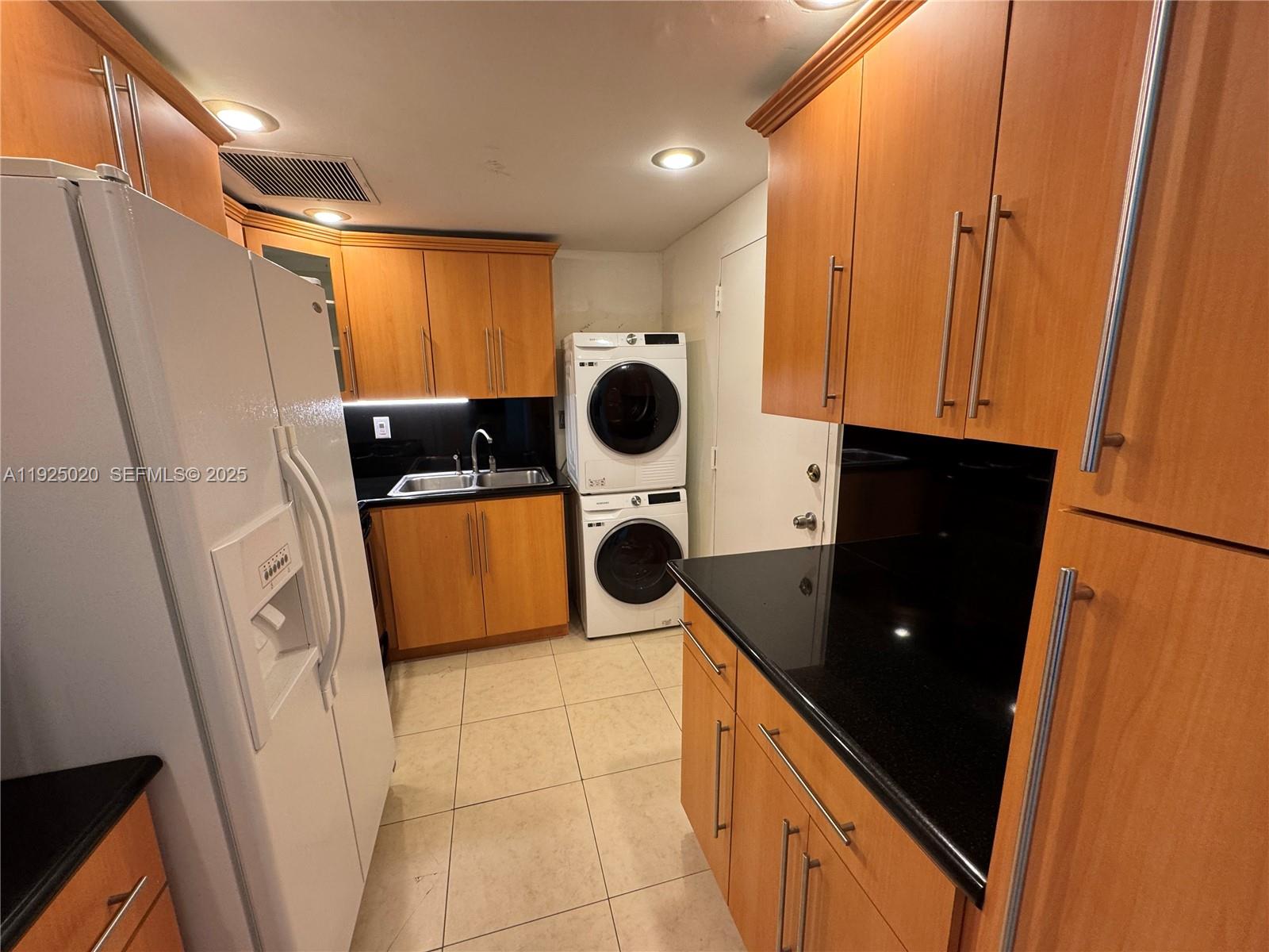 a kitchen with a refrigerator and a stove