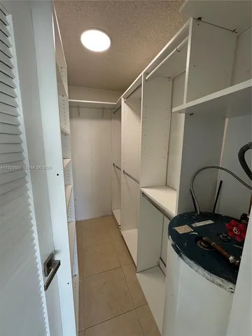 a view of a storage and utility room with a sink