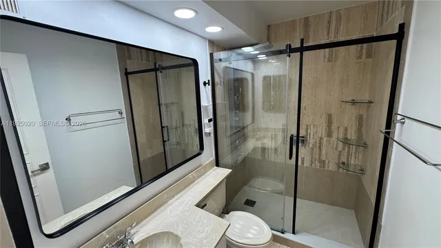 a bathroom with a shower toilet and sink