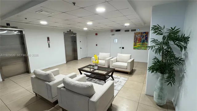 a living room with furniture and a potted plant