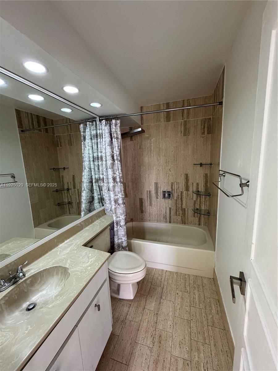 145 Southeast 25th Road, Unit 601 Miami, FL 33129 - Photo 4 of 5 a bathroom with a sink a toilet a mirror and shower