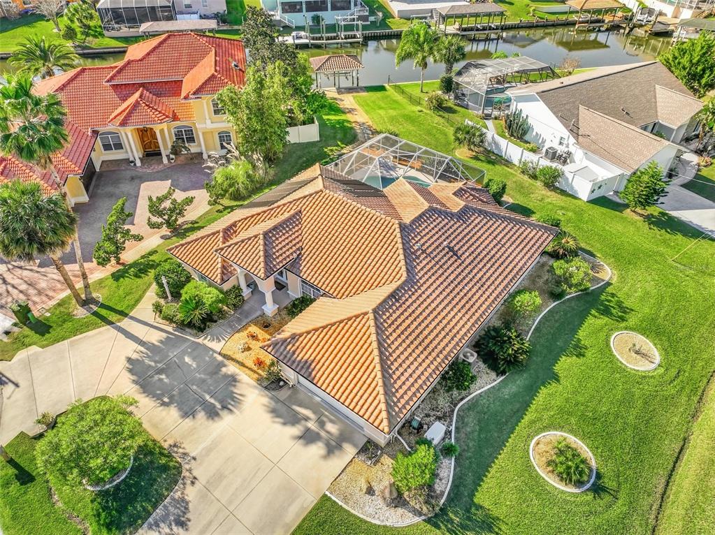 an aerial view of a house with garden space and street view