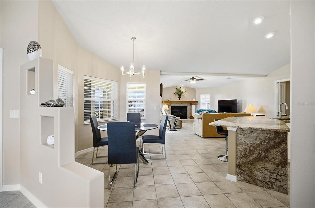 2 Cher Court Palm Coast, FL 32137 - Photo 13 of 64 a living room with furniture a fireplace and a chandelier
